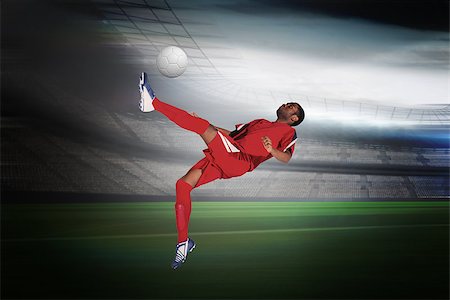 simsearch:400-07665266,k - Football player in red kicking in a large football stadium with lights Stock Photo - Budget Royalty-Free & Subscription, Code: 400-07525904