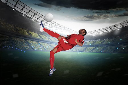 simsearch:400-07665266,k - Football player in red kicking in a large football stadium with lights Stock Photo - Budget Royalty-Free & Subscription, Code: 400-07525918