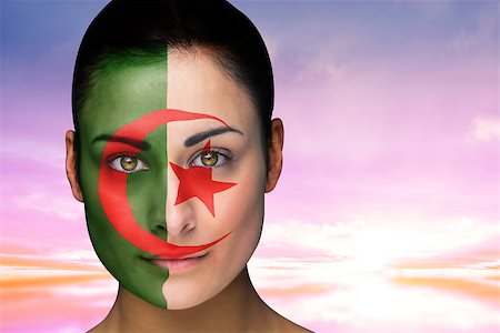 Composite image of beautiful brunette in algeria facepaint against beautiful blue and yellow sky Stock Photo - Budget Royalty-Free & Subscription, Code: 400-07526083