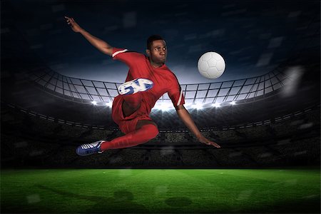 simsearch:400-07665266,k - Football player in red kicking against large football stadium with fans in yellow Stock Photo - Budget Royalty-Free & Subscription, Code: 400-07526197