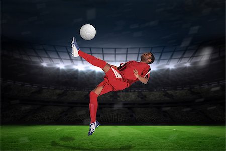 simsearch:400-07665266,k - Football player in red kicking against large football stadium with fans in yellow Stock Photo - Budget Royalty-Free & Subscription, Code: 400-07526193