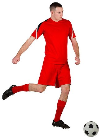 football man kicking white background - Fit football player playing with ball on white background Stock Photo - Budget Royalty-Free & Subscription, Code: 400-07526536