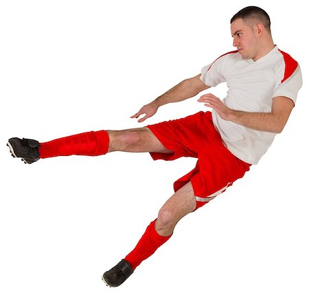 simsearch:400-07527479,k - Fit football player playing and kicking on white background Stock Photo - Budget Royalty-Free & Subscription, Code: 400-07526627