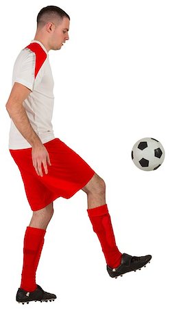 football man kicking white background - Fit football player playing with ball on white background Stock Photo - Budget Royalty-Free & Subscription, Code: 400-07526622