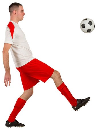 football man kicking white background - Fit football player playing with ball on white background Stock Photo - Budget Royalty-Free & Subscription, Code: 400-07526623