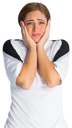 Pretty football fan looking nervous on white background Stock Photo - Budget Royalty-Free & Subscription, Code: 400-07526696