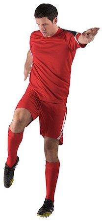 football man kicking white background - Football player in red kicking on white background Stock Photo - Budget Royalty-Free & Subscription, Code: 400-07526711
