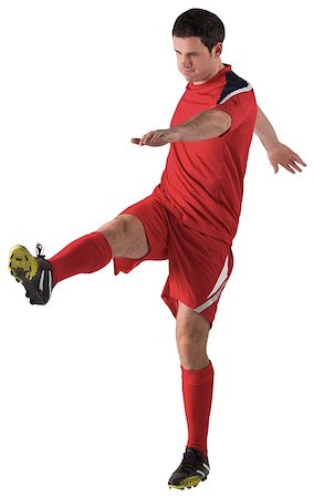 football man kicking white background - Football player in red kicking on white background Stock Photo - Budget Royalty-Free & Subscription, Code: 400-07526712