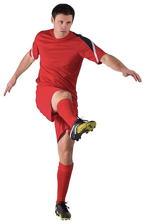 football man kicking white background - Football player in red kicking on white background Stock Photo - Budget Royalty-Free & Subscription, Code: 400-07526713