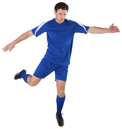 football man kicking white background - Football player in blue kicking on white background Stock Photo - Budget Royalty-Free & Subscription, Code: 400-07526756