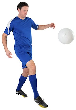 football man kicking white background - Football player in blue kicking on white background Stock Photo - Budget Royalty-Free & Subscription, Code: 400-07526758