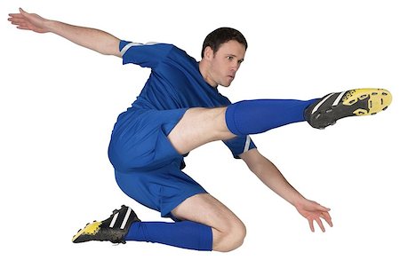 football man kicking white background - Football player in blue kicking on white background Stock Photo - Budget Royalty-Free & Subscription, Code: 400-07526765