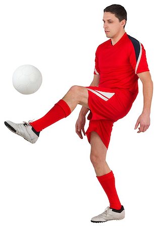simsearch:400-07527479,k - Fit young football player kicking on white background Stock Photo - Budget Royalty-Free & Subscription, Code: 400-07526885