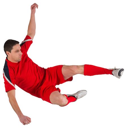 simsearch:400-07526712,k - Fit football player jumping and kicking on white background Stock Photo - Budget Royalty-Free & Subscription, Code: 400-07526889