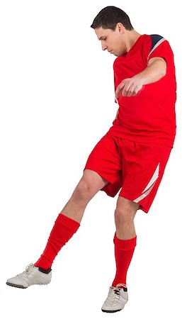 simsearch:400-07527479,k - Fit young football player kicking on white background Stock Photo - Budget Royalty-Free & Subscription, Code: 400-07526880