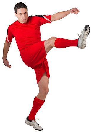 football man kicking white background - Fit young football player kicking on white background Stock Photo - Budget Royalty-Free & Subscription, Code: 400-07526882
