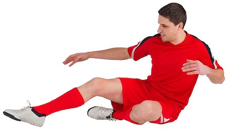 simsearch:400-07527479,k - Fit football player jumping and kicking on white background Stock Photo - Budget Royalty-Free & Subscription, Code: 400-07526891