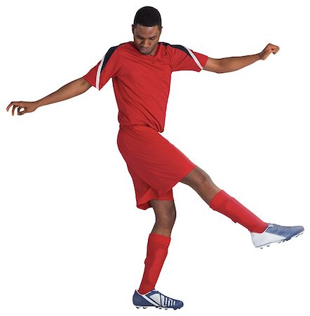 football man kicking white background - Football player in red kicking on white background Stock Photo - Budget Royalty-Free & Subscription, Code: 400-07527098
