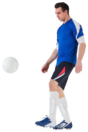 football man kicking white background - Football player in blue kicking ball on white background Stock Photo - Budget Royalty-Free & Subscription, Code: 400-07527192