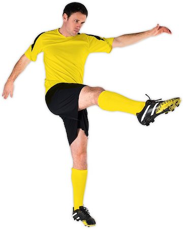 football man kicking white background - Football player in yellow kicking on white background Stock Photo - Budget Royalty-Free & Subscription, Code: 400-07527478