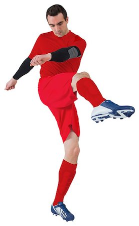 football man kicking white background - Football player in red kicking on white background Stock Photo - Budget Royalty-Free & Subscription, Code: 400-07527479