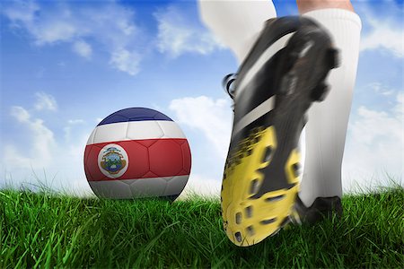 Composite image of football boot kicking costa rica ball against field of grass under blue sky Stock Photo - Budget Royalty-Free & Subscription, Code: 400-07527550
