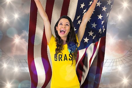 Excited football fan in brasil tshirt holding usa flag against large football stadium under cloudy blue sky Stock Photo - Budget Royalty-Free & Subscription, Code: 400-07527837