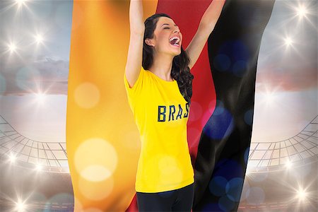 stadium in germany - Excited football fan in brasil tshirt holding germany flag against large football stadium under cloudy blue sky Stock Photo - Budget Royalty-Free & Subscription, Code: 400-07527839