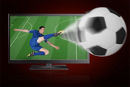 Football player in blue kicking ball out of tv against red background with vignette Stock Photo - Budget Royalty-Free & Subscription, Code: 400-07527855