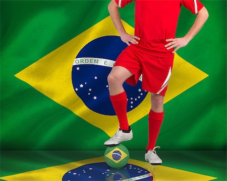 simsearch:400-07527966,k - Composite image of football player standing with ball against digitally generated brazilian national flag Foto de stock - Royalty-Free Super Valor e Assinatura, Número: 400-07527906
