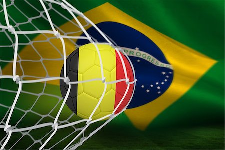 simsearch:400-07527960,k - Football in germany colours at back of net against brazilian flag waving Stock Photo - Budget Royalty-Free & Subscription, Code: 400-07528127