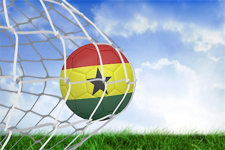 simsearch:858-03052829,k - Football in ghana colours at back of net against field of grass under blue sky Fotografie stock - Microstock e Abbonamento, Codice: 400-07528145