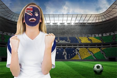 Excited australia fan in face paint cheering against large football stadium with brasilian fans Stock Photo - Budget Royalty-Free & Subscription, Code: 400-07528216