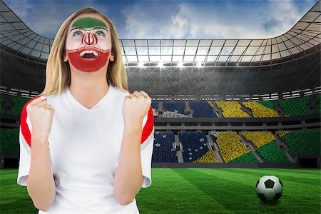 Excited iran fan in face paint cheering against large football stadium with brasilian fans Stock Photo - Budget Royalty-Free & Subscription, Code: 400-07528239