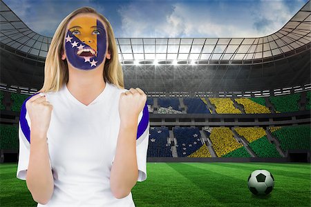 Excited bosnia fan in face paint cheering against large football stadium with brasilian fans Stock Photo - Budget Royalty-Free & Subscription, Code: 400-07528231