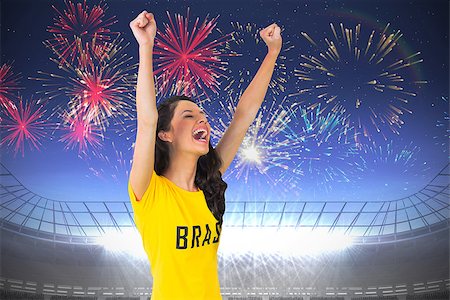 Excited football fan in brasil tshirt against fireworks exploding over football stadium Foto de stock - Super Valor sin royalties y Suscripción, Código: 400-07528249