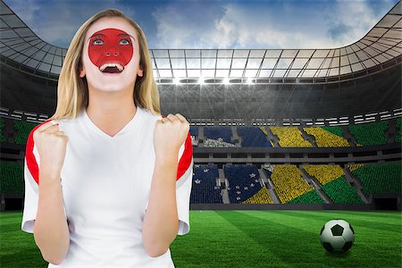 Excited japan fan in face paint cheering against large football stadium with brasilian fans Stock Photo - Budget Royalty-Free & Subscription, Code: 400-07528242