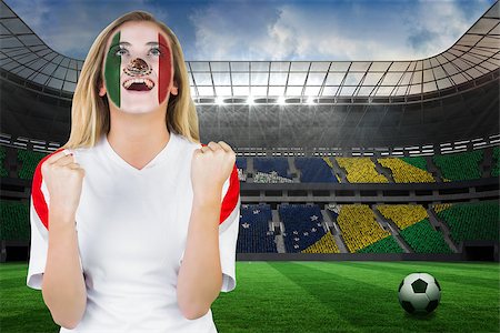 Excited mexico fan in face paint cheering against large football stadium with brasilian fans Stock Photo - Budget Royalty-Free & Subscription, Code: 400-07528243