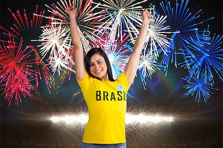 Excited football fan in brasil tshirt against fireworks exploding over football stadium Foto de stock - Super Valor sin royalties y Suscripción, Código: 400-07528252