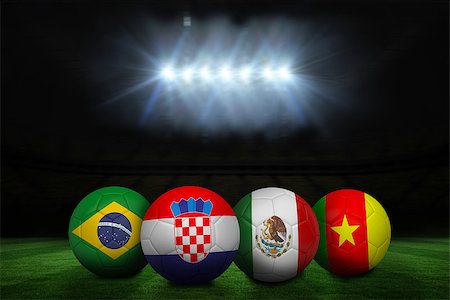 simsearch:400-04155683,k - Group a world cup footballs under spotlight on football pitch Stock Photo - Budget Royalty-Free & Subscription, Code: 400-07528261