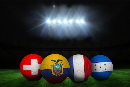 simsearch:400-07527966,k - Group e world cup footballs under spotlight on pitch Foto de stock - Royalty-Free Super Valor e Assinatura, Número: 400-07528270