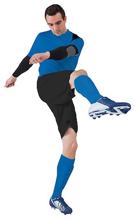 football man kicking white background - Football player in blue kicking on white background Stock Photo - Budget Royalty-Free & Subscription, Code: 400-07528298