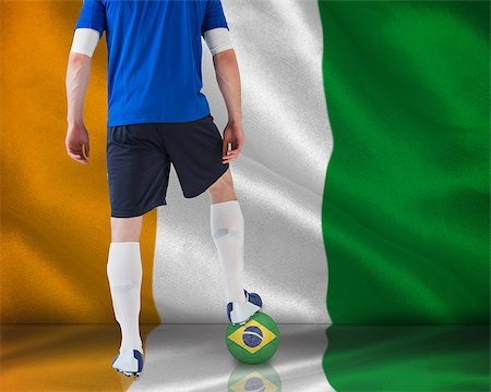 simsearch:400-07527966,k - Handsome football player in blue jersey against ivory coast national flag Foto de stock - Royalty-Free Super Valor e Assinatura, Número: 400-07528317