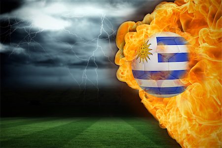 Composite image of fire surrounding uruguay flag football against football pitch under stormy sky Stock Photo - Budget Royalty-Free & Subscription, Code: 400-07528497