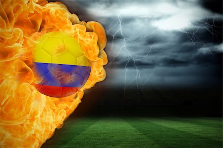 Composite image of fire surrounding colombia flag football against football pitch under stormy sky Stock Photo - Budget Royalty-Free & Subscription, Code: 400-07528504