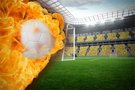 Composite image of fire surrounding football against vast football stadium with fans in yellow Stock Photo - Budget Royalty-Free & Subscription, Code: 400-07528515