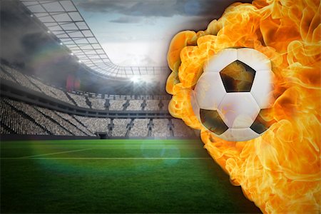 Composite image of fire surrounding football against large football stadium with lights Stock Photo - Budget Royalty-Free & Subscription, Code: 400-07528516