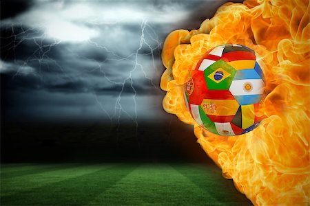 Composite image of fire surrounding international flag football against football pitch under stormy sky Stock Photo - Budget Royalty-Free & Subscription, Code: 400-07528517