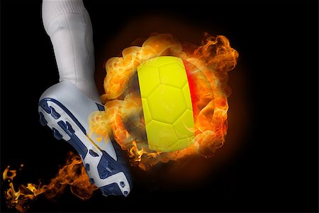simsearch:400-07527960,k - Football player kicking flaming belgium ball against black Stock Photo - Budget Royalty-Free & Subscription, Code: 400-07528537