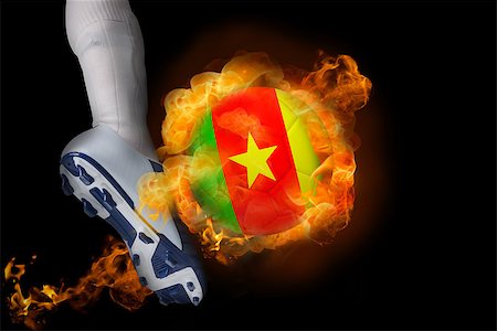 simsearch:400-07527960,k - Football player kicking flaming cameroon ball against black Stock Photo - Budget Royalty-Free & Subscription, Code: 400-07528539